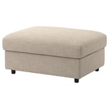 Beige VIMLE footstool, rectangular shaped with black legs, upholstered in patterned fabric, offering hidden storage space.