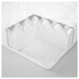 White, cushioned seat with wavy sides; probably consists of foam and polyester.
