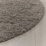 Fluffy gray rug with anti-slip backing on wooden floor.