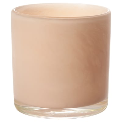 The VINDSTILLA candle is a handcrafted peach-colored glass holder, uniquely shaped and patterned.