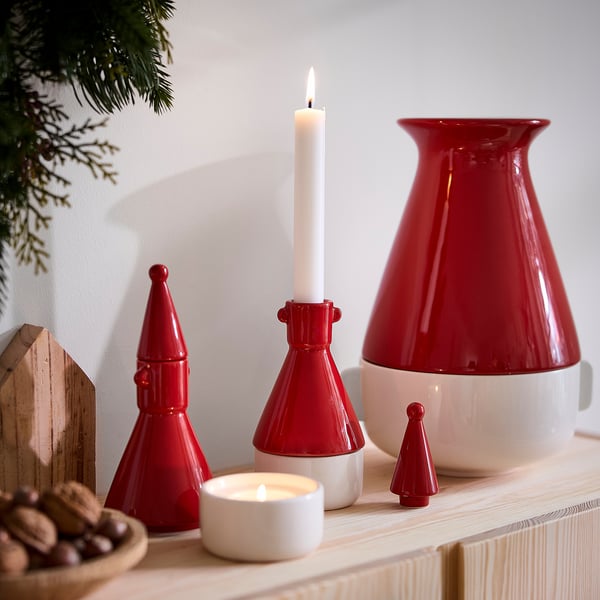 Red ceramic VINTERFINT figures and vases with lit candles, display cosy holiday decor.