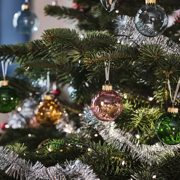 Christmas tree with green, clear, pink ornaments, festive.