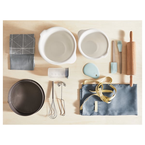 Kitchen items: bowls, cloths, pan, tools, roller, cup, whisk, tongs, ribbon.