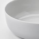 Modern, minimalist white glass bowl, smooth edges, polished finish, reflecting light.
