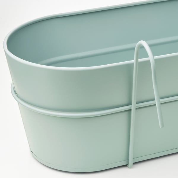 Light blue galvanized steel planter with sturdy handle, suitable for hanging or placing, corrosion-resistant.