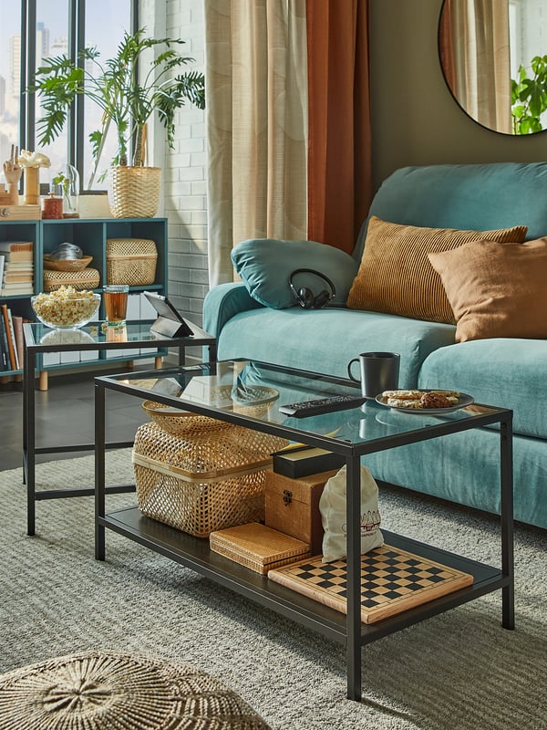 Cozy living room with teal sofa, wooden coffee table, and woven baskets.