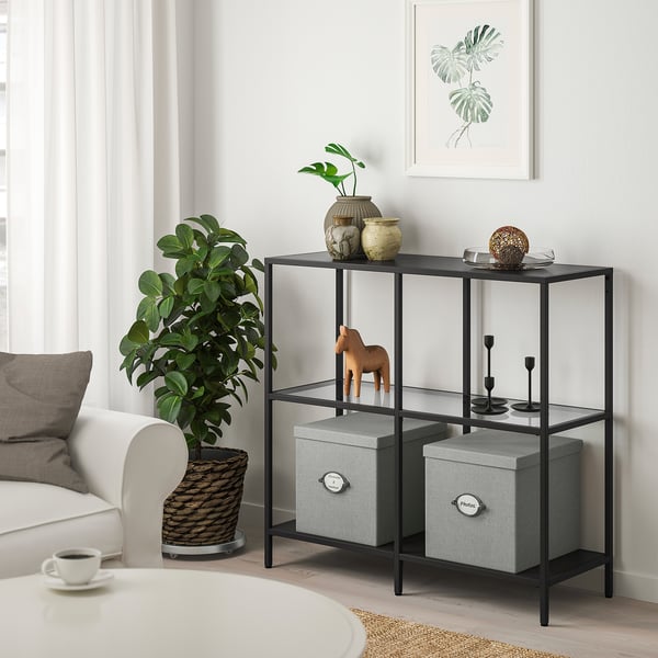VITTSJÖ shelf holds decor, vases, horse figurine, storage boxes.