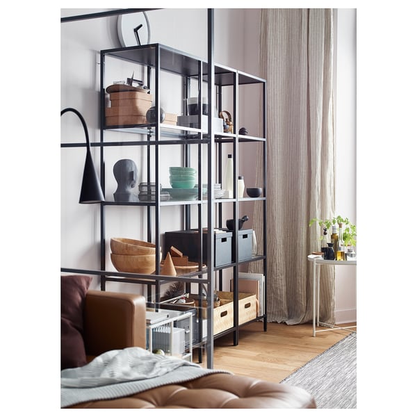 Modern living room with VITTSJÖ shelf, sofa, window.