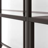 Modern metal shelf with clear glass panels, well-crafted for stability and style.