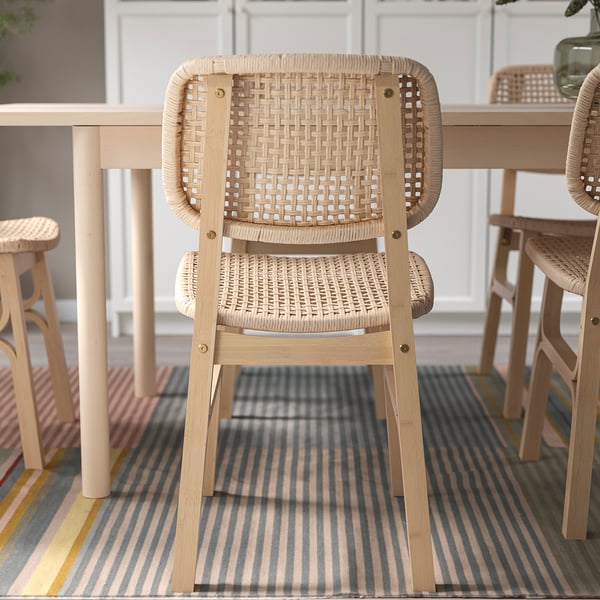 Stylish woven chair with wooden frame, offering comfort and support, ideal for indoor use.