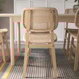 Stylish woven chair with wooden frame, offering comfort and support, ideal for indoor use.