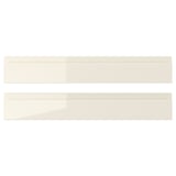 Two beige high-gloss VOXTORP drawer fronts with sleek, integrated handles.
