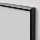 Black empty picture frame hangs on white wall. Slim design, snap-on feature.