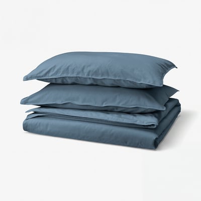 A stack of blue bedding set including two pillows and a duvet cover. Soft and casual, made of 100% cotton.
