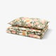 Floral bedding set with pastel flowers on beige. Silky cotton/lyocell fabric, neatly folded.