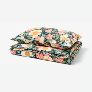 Blue floral bedding with pink, white, yellow flowers on dark blue base, 50% cotton, 50% lyocell, silky sateen weave.