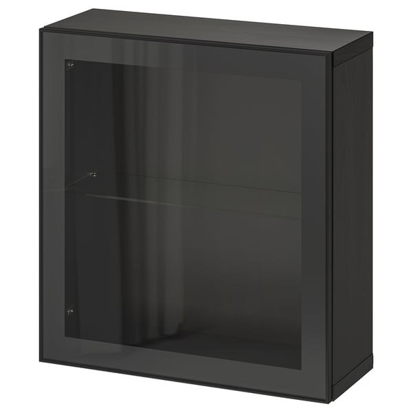 A black IKEA BESTÅ storage unit with a glass door and glossy finish. Its rectangular, featuring a glass shelf inside and a sleek, modern design.