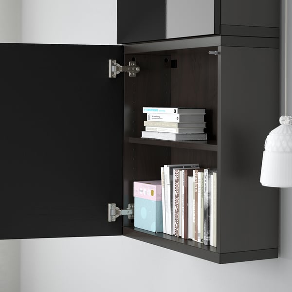 Black wall-mounted cabinet with two shelves, storing books and magazines. Part of the BESTÅ storage solution.