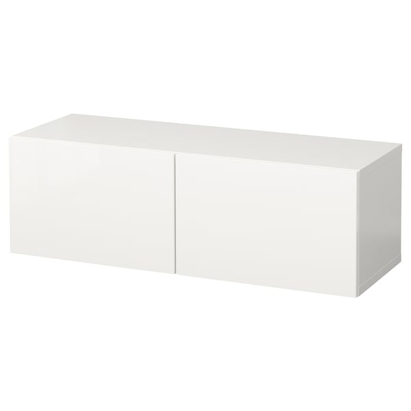 A white BESTÅ storage unit, rectangular in shape, with two doors. Its sleek, modern, and made of particleboard and fiberboard.