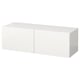 A white BESTÅ storage unit, rectangular in shape, with two doors. Its sleek, modern, and made of particleboard and fiberboard.