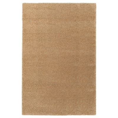 A beige rectangular area rug named BREVBÄRARE, made of polypropylene and synthetic rubber.