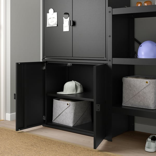 Black storage cabinet holds hat and box, with grey felt baskets on shelves.