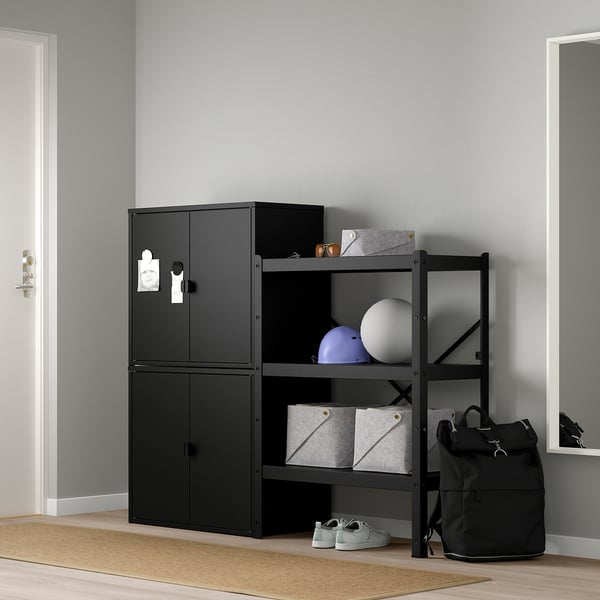 Black BROR storage system, featuring cabinet & open shelves. Holds various items, taller than a backpack, fits near a door.