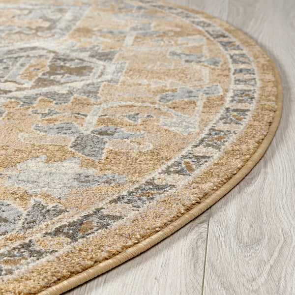Rounded area rug with intricate beige and grey patterns, laid on light wooden floor, showcasing its durable and stylish design.