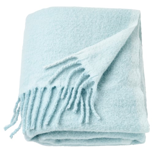 Light blue, soft recycled polyester throw with fringe detail, folded neatly.