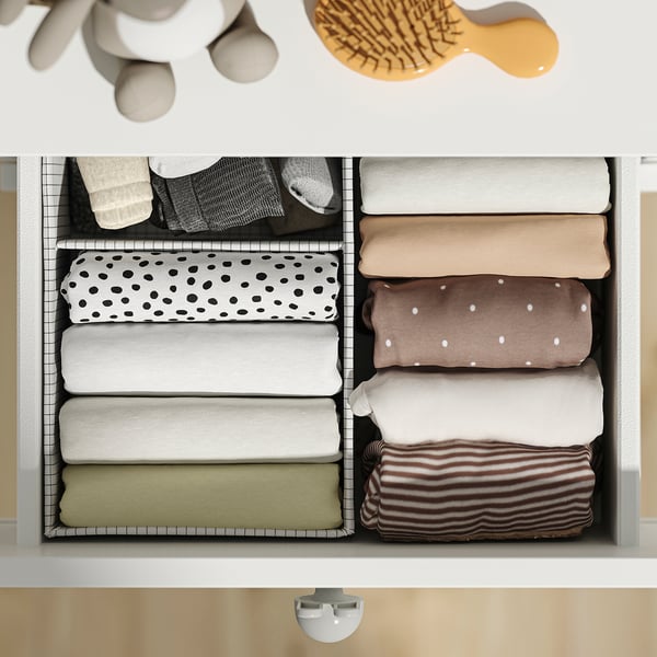 Neatly organised drawer with folded clothes. Includes dividers and automatic closing feature.