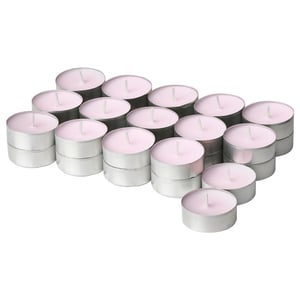 Set of pink tea light candles in silver holders, arranged in a cluster.