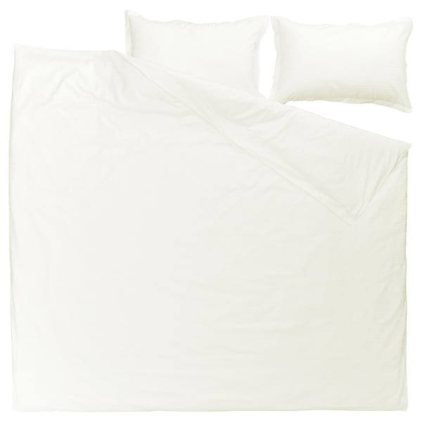 A white LUKTVICKER duvet cover set with a waffle weave design, made from 100% cotton, neatly folded with two pillows.