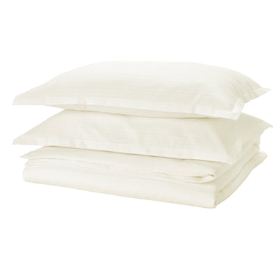 LUKTVICKER: clean white cotton duvet set, waffle design, neatly folded for fresh look.