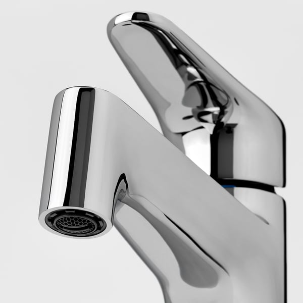 Close-up of modern, chrome-plated tap with sleek, angular design. Easy removal aerator at tip for efficient water flow.