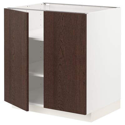 A white and dark brown kitchen cabinet from the METOD system with oak veneer and solid wood edges.
