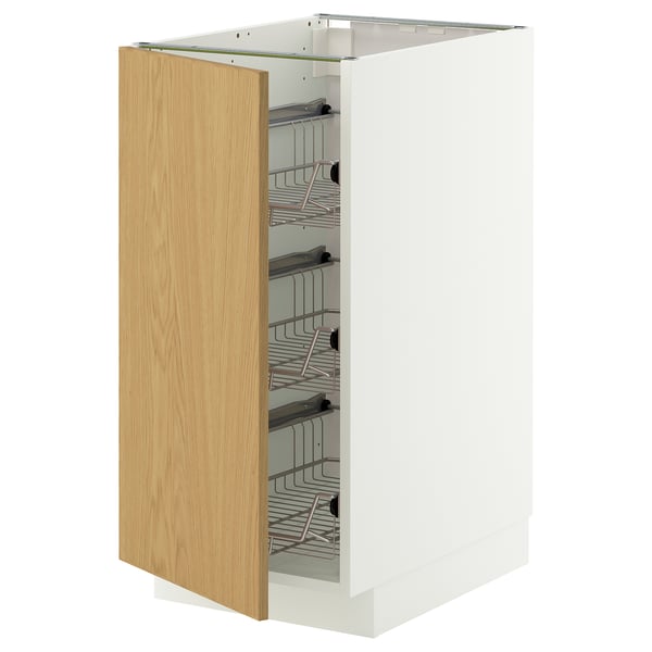 Modern white kitchen cabinet with wooden door open, metal wire shelves.