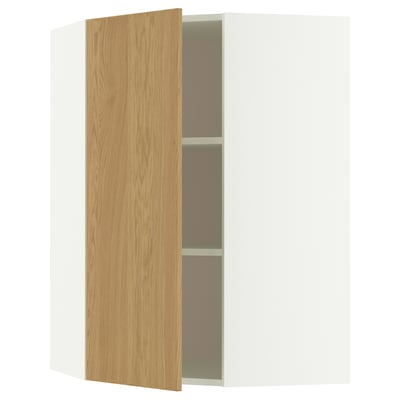 A METOD corner cabinet with light oak doors and white frame. It has one open door revealing two shelves inside.