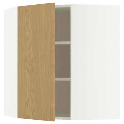An oak-veneered corner cabinet with two shelves, showing storage inside.