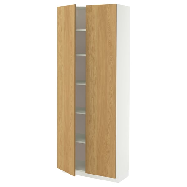 Wooden IKEA METOD tall cabinet with adjustable shelves and 25-year guarantee. Partially open door.