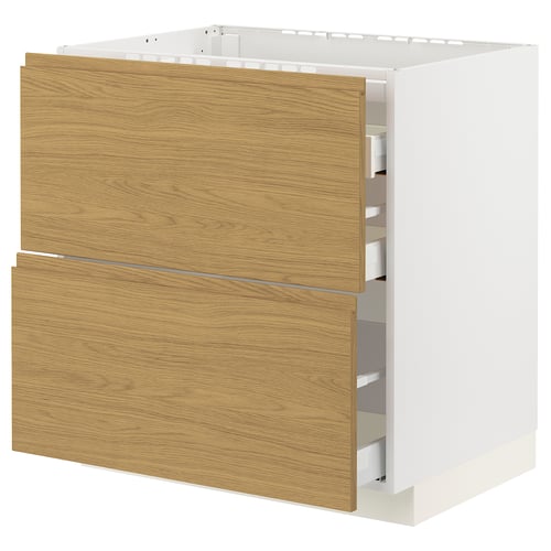 Modern kitchen cabinet with oak-wood texture drawer fronts and sleek minimalist handles, part of the METOD system.
