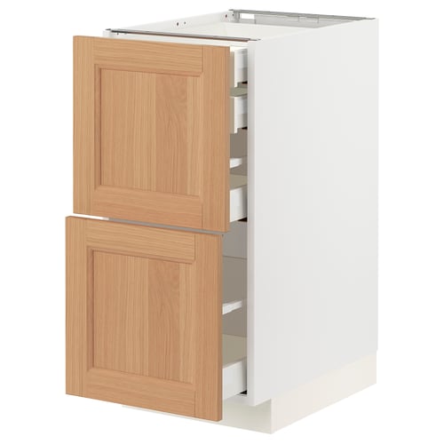 White kitchen cabinet with wooden drawers, featuring multiple sliding drawers.