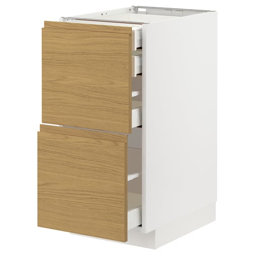 Modern kitchen unit with oak-effect drawers and white cabinet. Four drawers in sleek design.