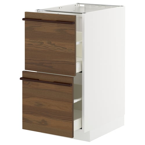 METOD kitchen cabinets with dark brown stained ash veneer drawers and white frames, designed with solid wood handles.