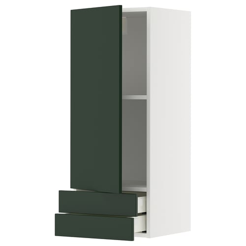 A METOD kitchen cabinet in deep green with white walls. It combines drawers and shelves, offering modern storage.