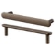 Two NYDALA brass-colored metal cabinet handles, one horizontal, one horizontal with vertical posts, textured finish.