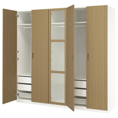 Modern light brown PAX closet with adjustable shelves and drawers, featuring mesh baskets and soft-closing doors.