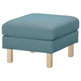 Blue cushioned footstool, wooden legs, recycled materials, square shape.