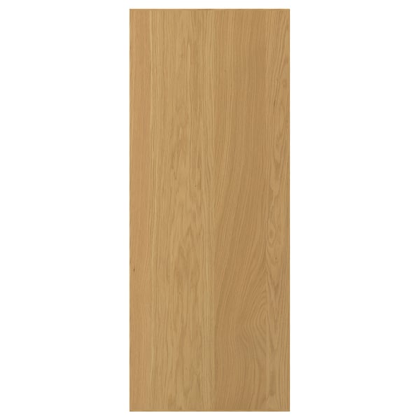 A light wooden door named SINARP. Its made of oak veneer and a solid wood edge. The door is rectangular and has a natural wood grain design.