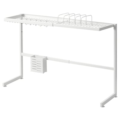 A white SKYGGFISK dish rack with multiple compartments, hooks, and a cutlery section. It sits over sinks, draining dishes efficiently.