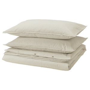 Three stacked striped pillows, light beige with white lines, rectangular shape, zippered closure.